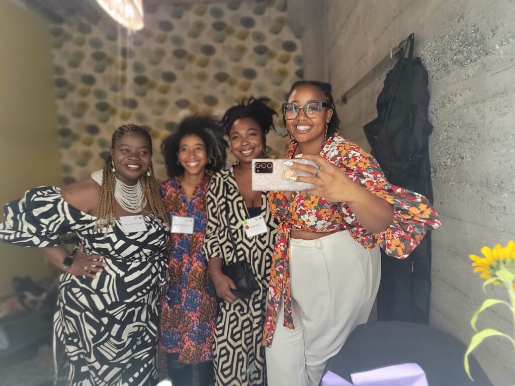 Selfie of Andriana Taylor Alexis and Valeriana Black women and femmes wearing stylish printed outfits posing together in a green room